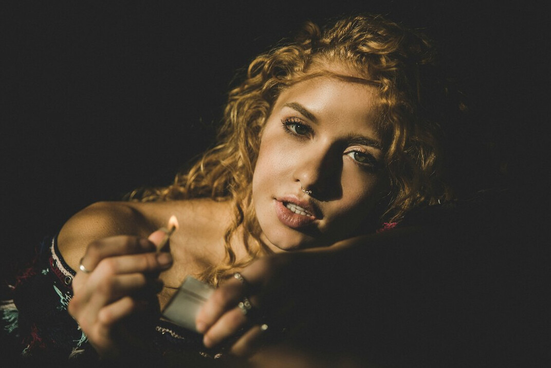 Studio portrait of a young woman with curly hair