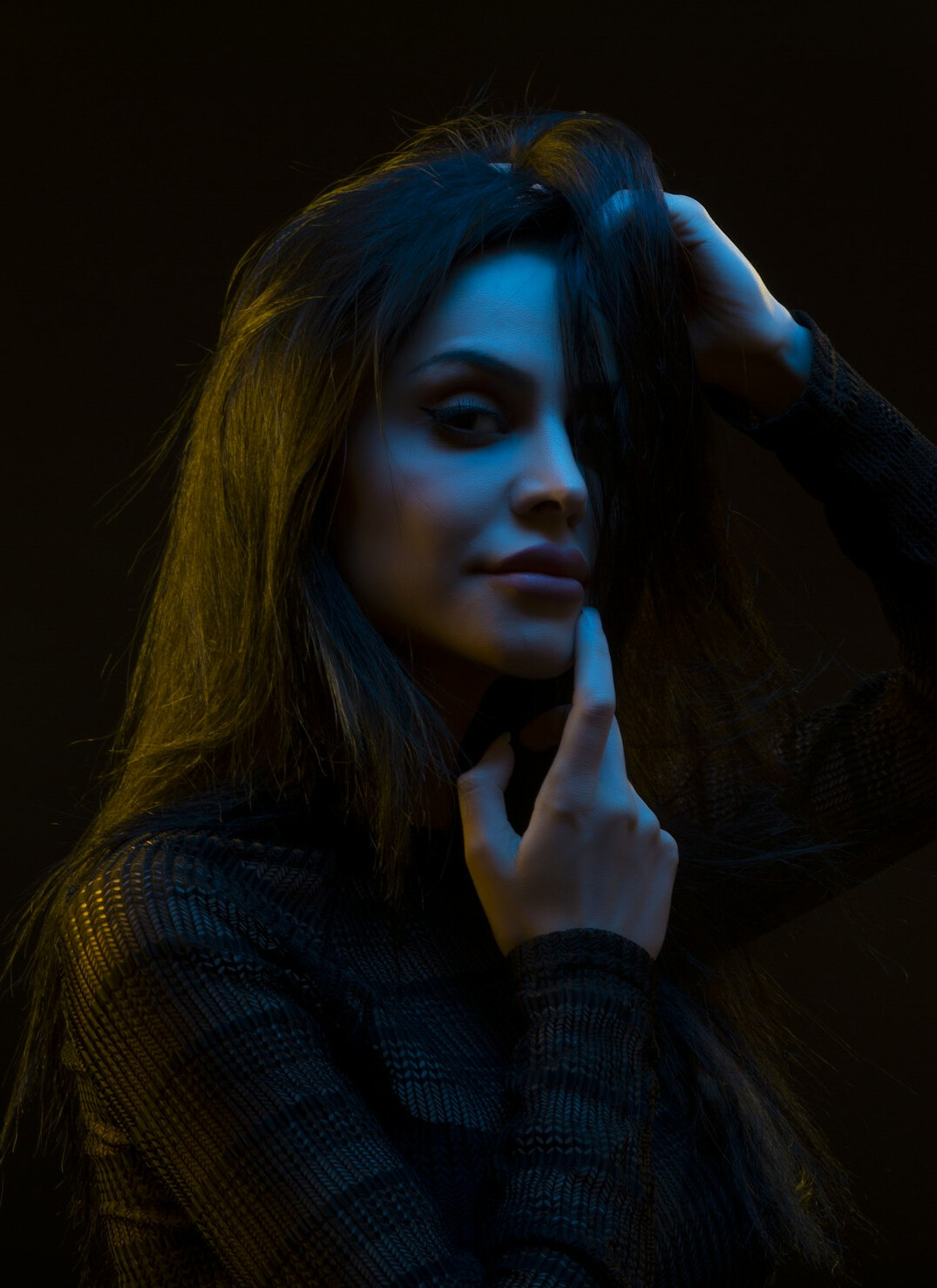 Studio portrait of a young woman with long dark hair