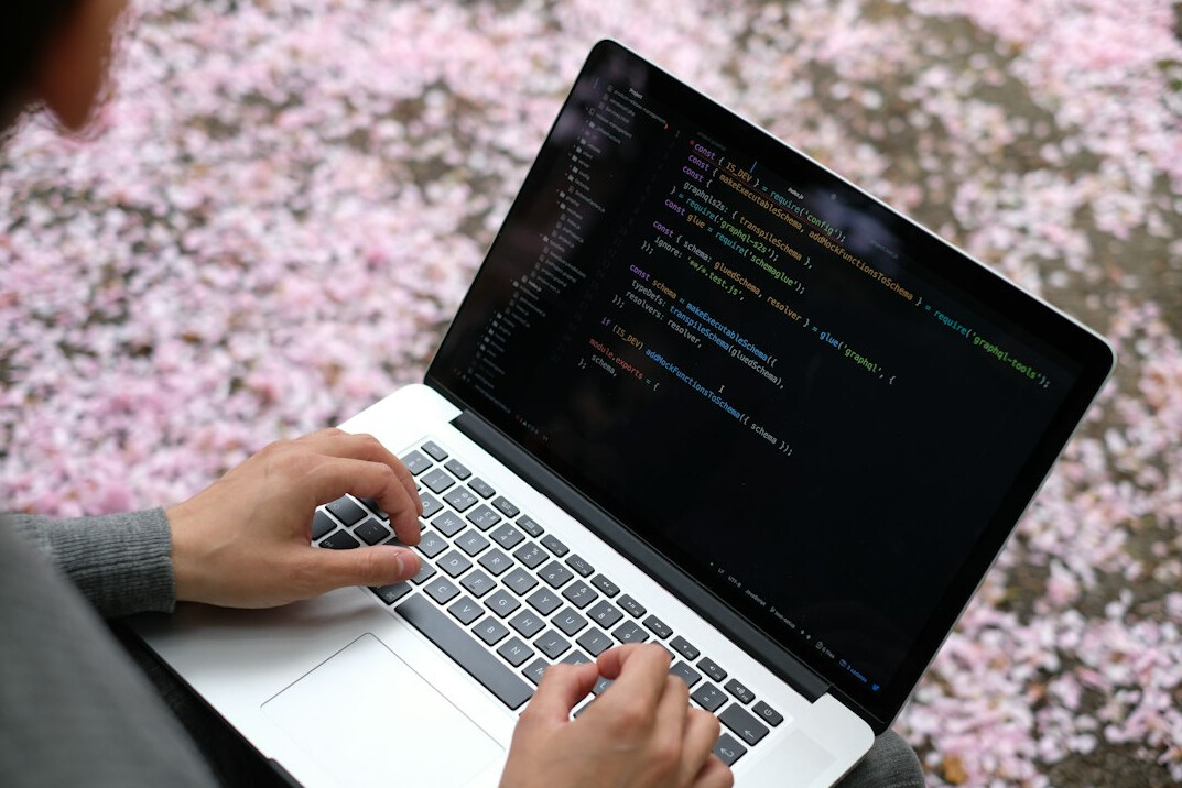 young woman coding on laptop