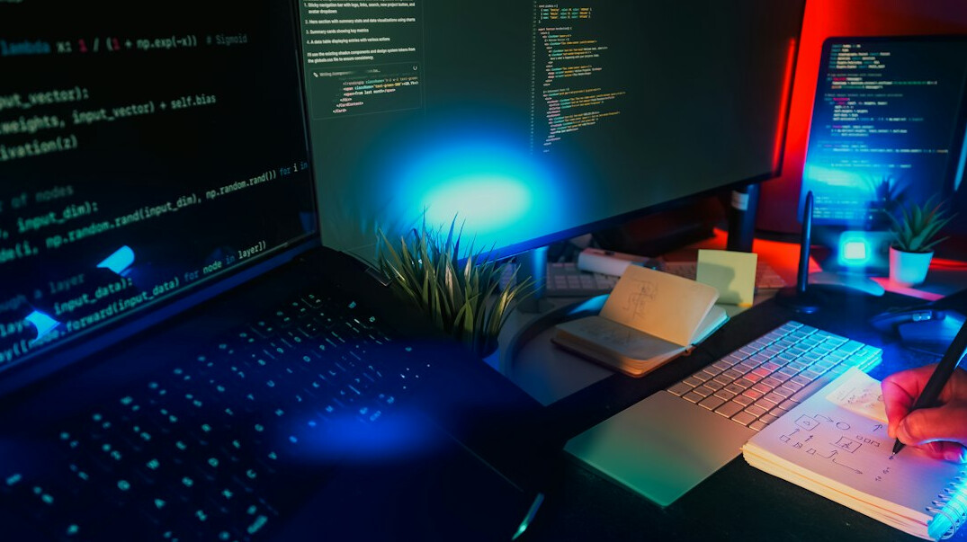 coding workspace with laptop and notes