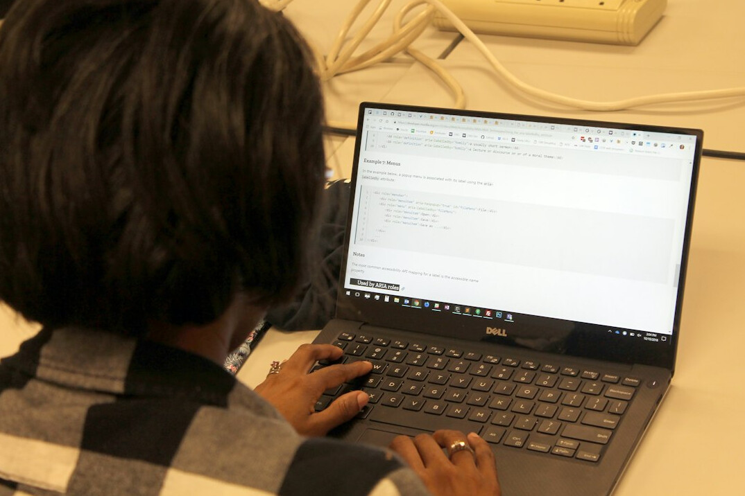 young person learning to code on laptop