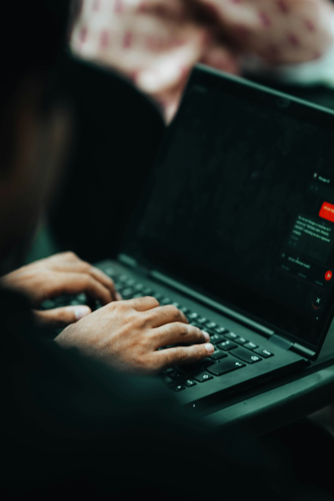 programmer typing code on laptop
