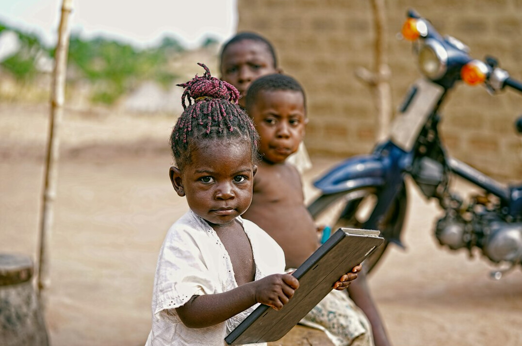 Small group looking at a laptop screen together